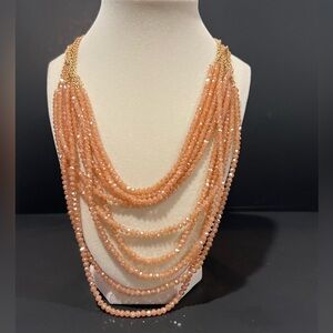 Multi-layered peach colored beaded necklace